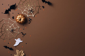 Wall Mural - Halloween party decorations from pumpkins, bats, spider web and ghosts top view. Happy halloween holiday greeting card flat lay style..