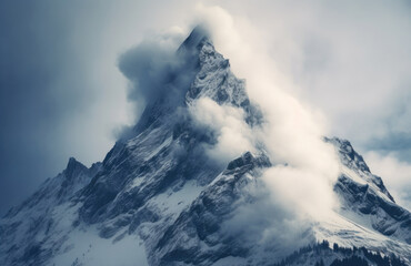 Wall Mural - A mountain peak covered in snow and clouds. The mountain peak is sharp and jagged, with a steep incline. The clouds are white and fluffy, and are covering the top and sides of the mountain