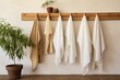 You will find a row of natural muslin kitchen towels gracefully displayed on a unique wooden hanger These kitchen textiles are made from natural soft breathable materials and bring a