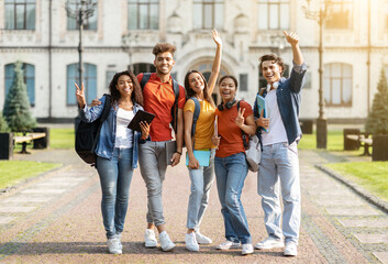 Wall Mural - Studentship Concept. Group Of Happy Multiethnic Students With Workbooks Posing Together Outdoors