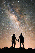 A Couple Silhouette With The Milky Way On A Background