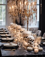 A Table Set For Halloween Party With Skulls, Candles And Candle Holders Hanging From The Chandels On Top
