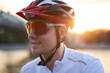 © nuclear_lily - Man is wearing protective helmet, sunglasses and sportswear during evening ride in city.