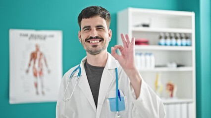 Sticker - Young hispanic man doctor doing ok gesture at clinic