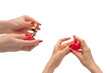 Red bottle of perfume in woman hand with red nails isolated on a white background.