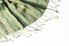 Green Fringed Scarf Fabric On White Background. Copy Space