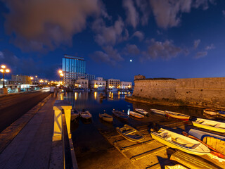 Wall Mural - Night in Gallipoli, province of Lecce, Puglia, southern Italy.  People and signs unrecognizable.