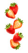 Whole and sliced fresh strawberry fruits in the air. Composition of falling summer berries, isolated on transparent background, PNG