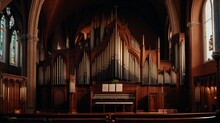 The Majestic Pipe Organ And Stained Glass Windows In A Magnificent Church