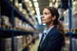 © Fred - Close up Portrait of a woman overlooking a vast warehouse strategizing storage solutions
