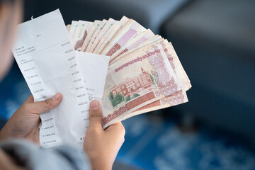 Asian man holding banknotes of Laos kip money the national currency of Laos. LAK