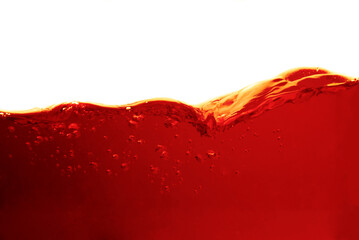 Wall Mural - red liquid in bright glass with splashes and bubbles isolated on white