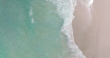 4K DCI 4096x2160p. Top-down View Aerial Beach Video Ocean Waves Roll Onto The Beautiful Beach. Filmed With High Quality Cinema Cameras. DCI 4K ProRes422