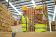 © FotoArtist - Woman with checklist in a timber and lumber warehouse. Product acceptance and quality control