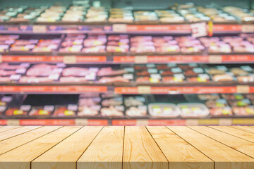 Sticker - Empty wood table top with blur meat shelves in supermarket background for product display