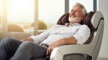 Senior Man Relaxing Therapy On The Massage Chair In Living Room. Modern Electric Massage Chair.