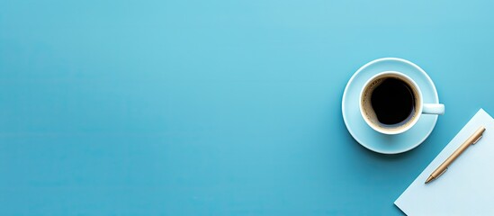 Poster - Flat lay view of a contemporary office table with a blue color scheme and a cup of coffee allowing for copying space