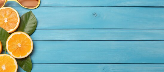 Aufkleber - Top view of blue wooden background with flip flops sunglasses and oranges offering copy space