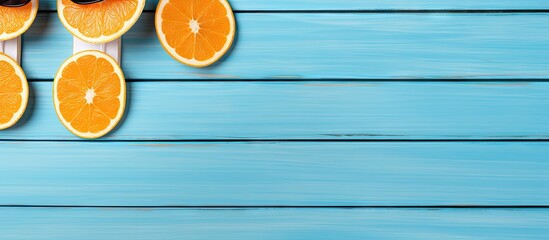 Aufkleber - Top view of blue wooden background with flip flops sunglasses and oranges offering copy space