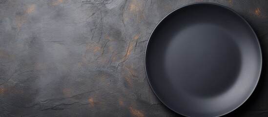 Poster - Copy space above dark stone background with empty black plate Overhead view