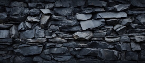 Fototapete - Texture and pile of rocks in a black stone background on a wall surface