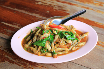 Canvas Print - Stir Fried Razor clams with chili and basil leaves in plate on wood table. Thai style food.