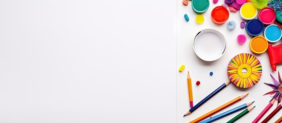 Poster - White table with sketchbook and crayons against a white background