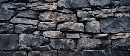 Fototapete - Texture and pile of rocks in a black stone background on a wall surface