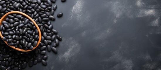Aufkleber - Raw black beans on gray concrete horizontal top view blank area