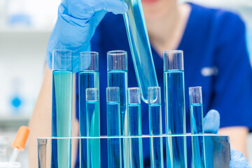 Wall Mural - laboratory glassware equipment for medicals science chemistry research, blue liquid in scientific gl