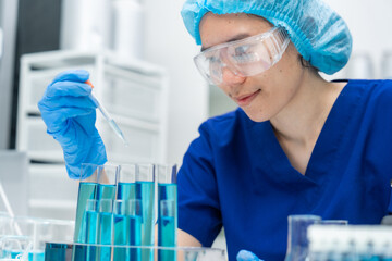 Wall Mural - laboratory glassware equipment for medicals science chemistry research, blue liquid in scientific gl