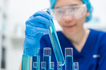 Wall Mural - laboratory glassware equipment for medicals science chemistry research, blue liquid in scientific gl