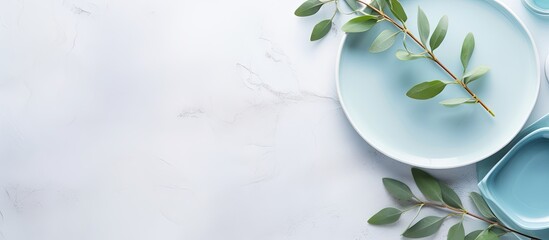 Aufkleber - Festive table arrangement for a celebration with blue plates eucalyptus branches and glass on a light background