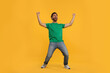 © New Africa - Emotional sports fan celebrating on orange background