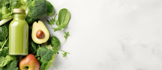 Poster - Top view of green smoothie surrounded by green fruits and vegetables on a simple white background emphasizing diet healthy nutrition detox concept Copy space available