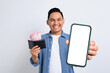 Excited young Asian man in casual shirt holding smartphone with blank screen and wallet full of cash isolated on white background