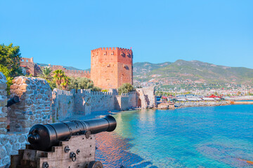Wall Mural - The famous red tower (Kizil Kule) with black cannon - The symbol of the resort town of Alanya - Alanya, Turkey