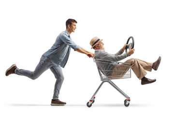 Wall Mural - Guy pushing his grandfather inside a shopping cart