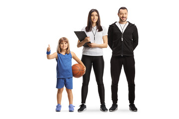 Wall Mural - Male and female coaches posing with a girl holding a basketball and gesturing thumbs up