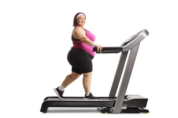 Sticker - Full length profile shot of an overweight woman working out on a treadmill