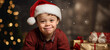 A boy with Down syndrome smiles in front of a Christmas tree. People with disabilities.
