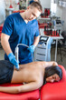 © puhimec - Extracorporeal shockwave therapy, physical therapy for neck and back muscles.