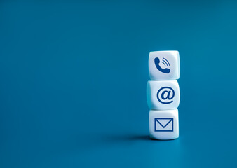 Poster - Contact us concept. Company website, FAQ, hotline phone number call, address and e-mail marketing for customer support . Contact us icons on wooden cube block stack on blue background with copy space.