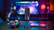Headphones, a microphone, and a mobile phone are arranged on a surface. In the background, a computer monitor displays a bokeh effect. The setup is ready for an audio podcast recording session. 