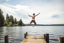 Young man jumping into the lake