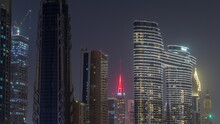 Many Towers And Skyscrapers With Traffic On Streets In Dubai Downtown And Financial District Night Timelapse.