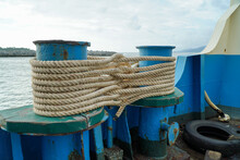 Rope Anchored The Boat Into The Harbor.Mooring Rope And Bollard 
