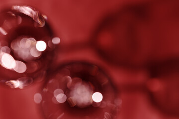 Wall Mural - wine glasses defocused, red wine color blurred background with light flare, optical blur, bokeh. top