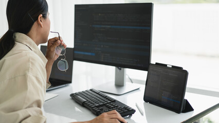 Developer programmer working to checking code on monitor while programming to developing website