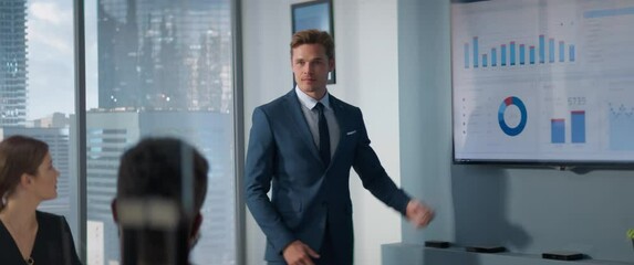 Aufkleber - Diverse Modern Skyscraper Office: Businessman Leads Business Meeting with Managers, Talks, uses Presentation TV with Statistics, Infographics. Entrepreneurs Work on e-Commerce Project. Anamorphic Shot